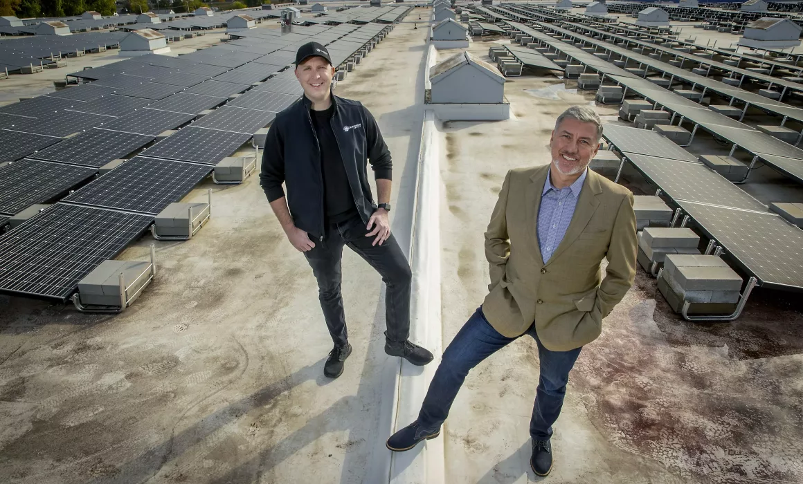 Griffin Dooling of Blue Horizon Group, left, and founder Christopher Wyffels of Superior Third Party Logistics stood on the solar roof of Superior, a warehouse and logistics firm in St. Paul. Photo credit: Liz Flores, Star Tribune